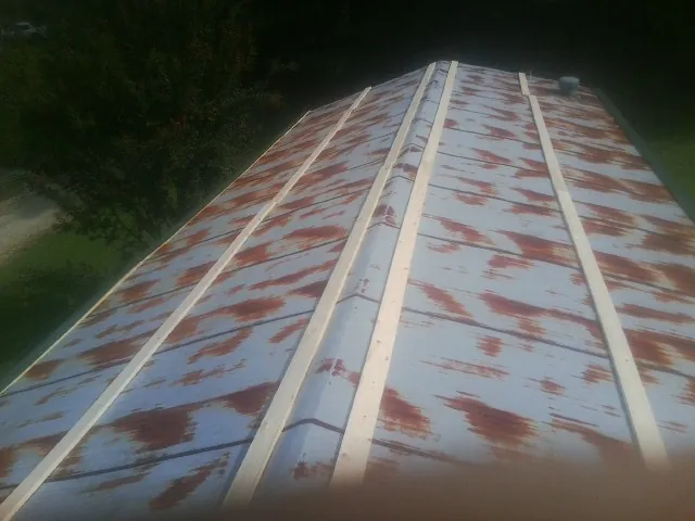 Rusted metal roof panels with new wood purlins before replacement — Storm Damage Roof Repair in Lemon Grove by Roofing Brothers