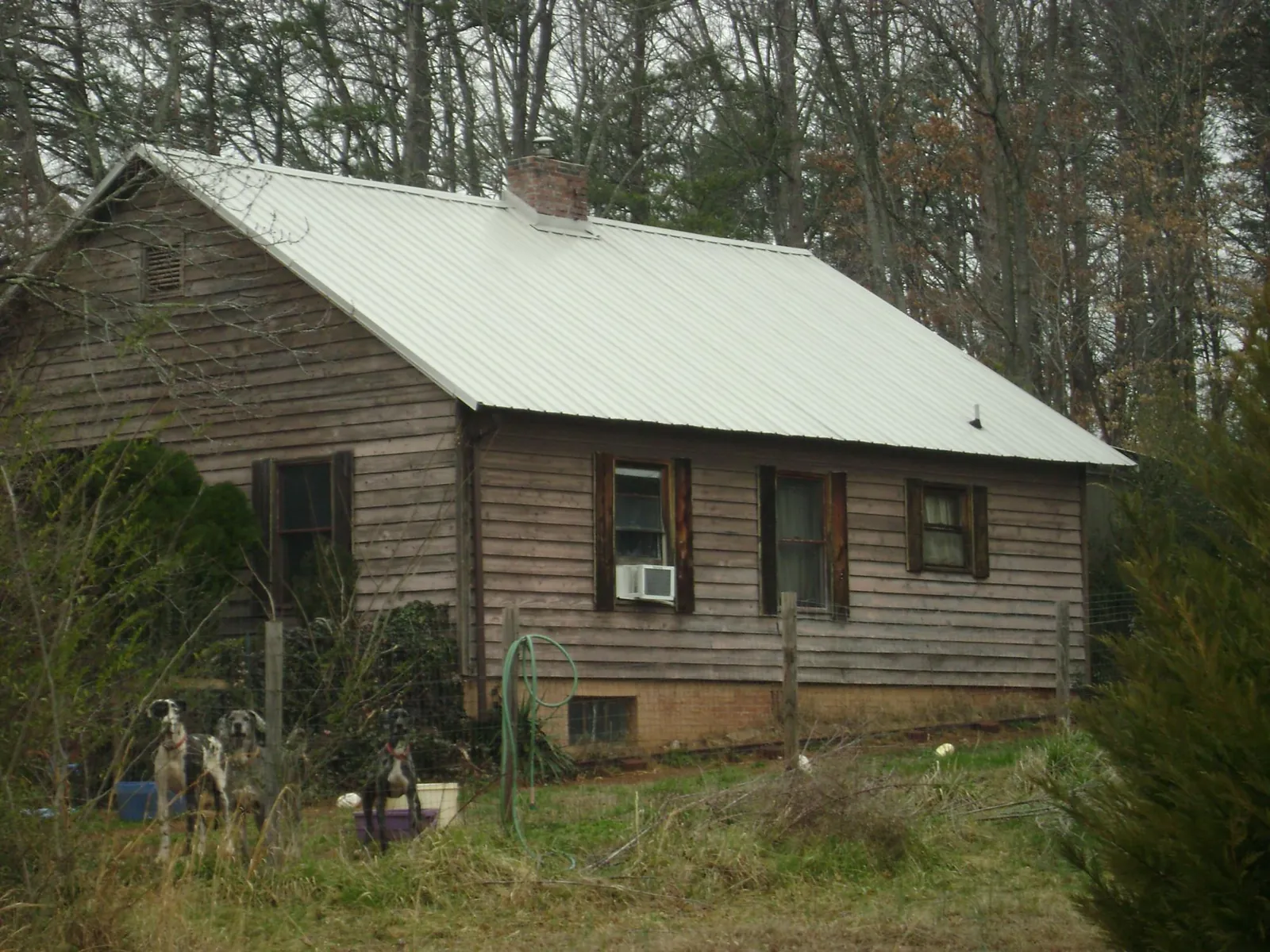 White metal roof on an old wood sided farmhouse, from a Metal Roof Installation job in Lemon Grove